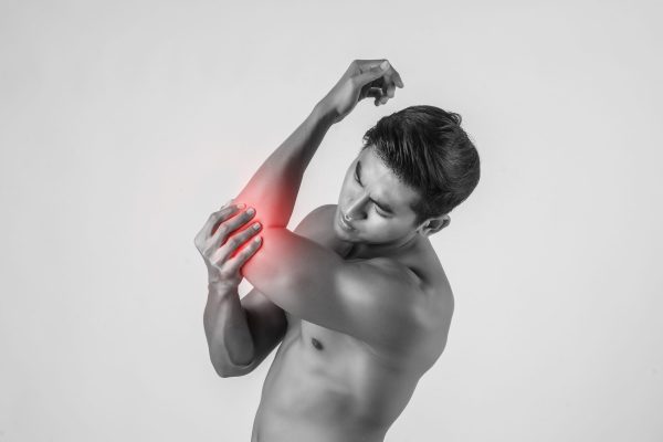 Portrait of a muscle man having elbow pain isolated on white background
